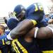 Michigan quarterback Devin Gardner hugs safety Thomas Gordon as they celebrate beating Northwestern 38-31 in overtime at Michigan Stadium on Saturday. Melanie Maxwell I AnnArbor.com